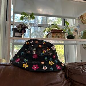Trixie Cosmetics women’s floral bucket hat merch with green Trixie logo